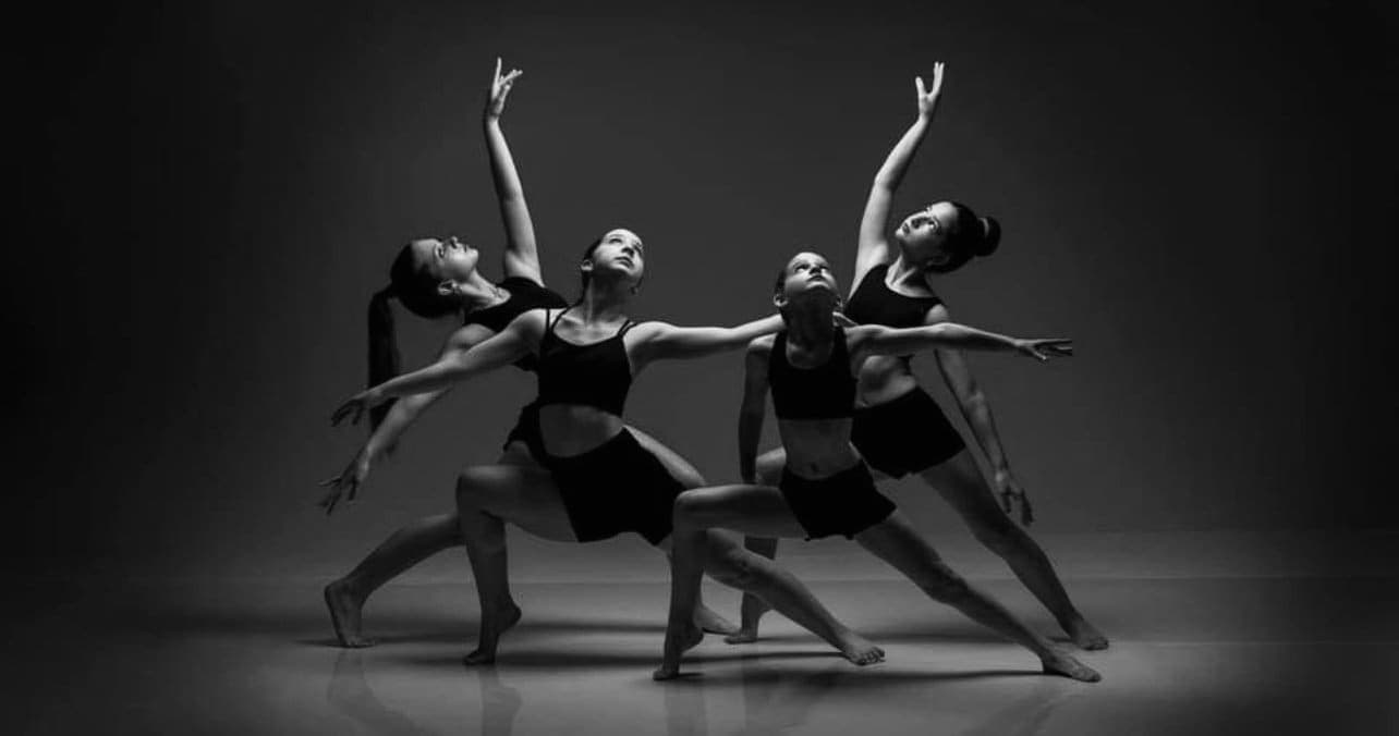 Ballet dancer silhouette against dark background