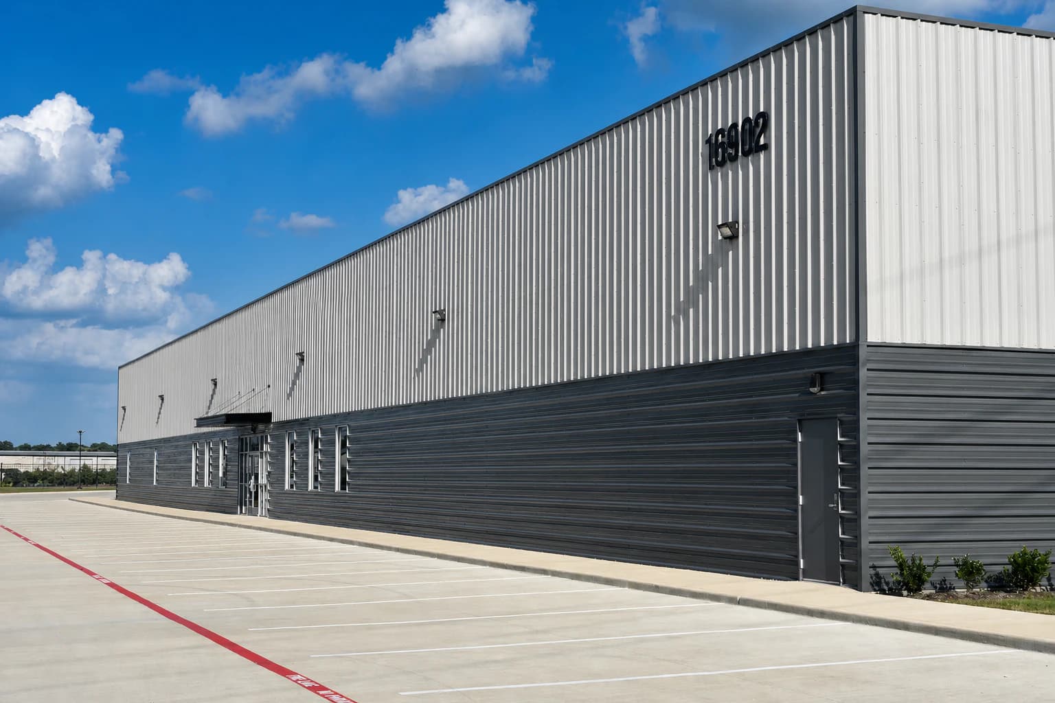 High-contrast exterior view of Cypress Elite Dance Studio and its empty parking area in Cypress, Texas